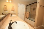 The downstairs full bath has a double vanity and is close to the 2nd and 3rd bedrooms.